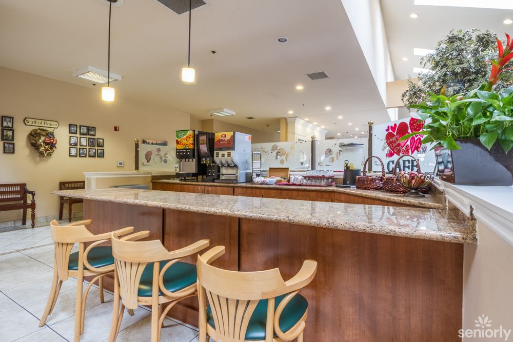 A modern cafe interior with a stylish counter and seating area.