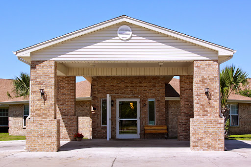 The inviting entrance of a brick building under a clear blue sky.