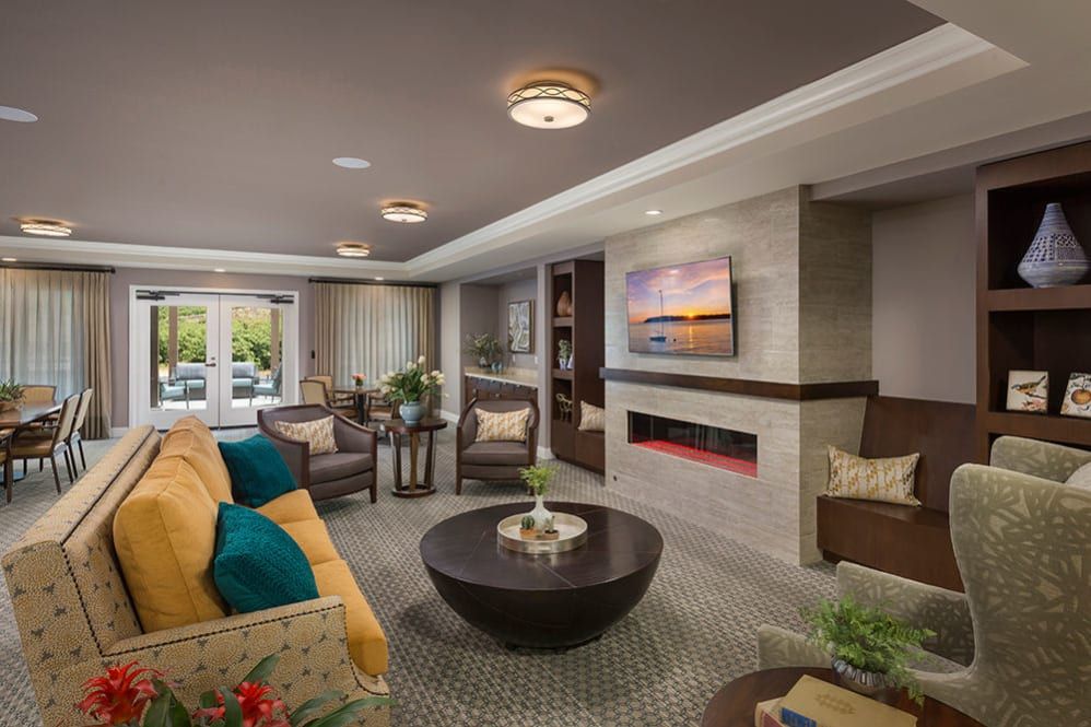 A modern and cozy living room with a fireplace, comfortable seating, and contemporary decor.