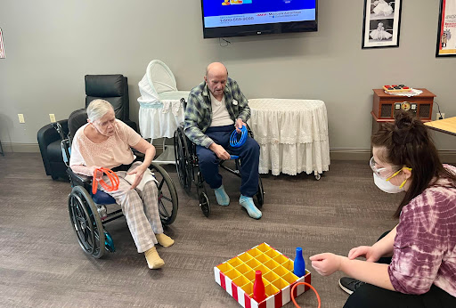 Residents enjoying a fun game activity in a care facility.