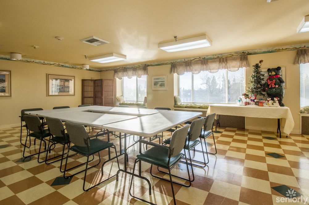 A well-lit conference room with a central table arrangement and checkered flooring.