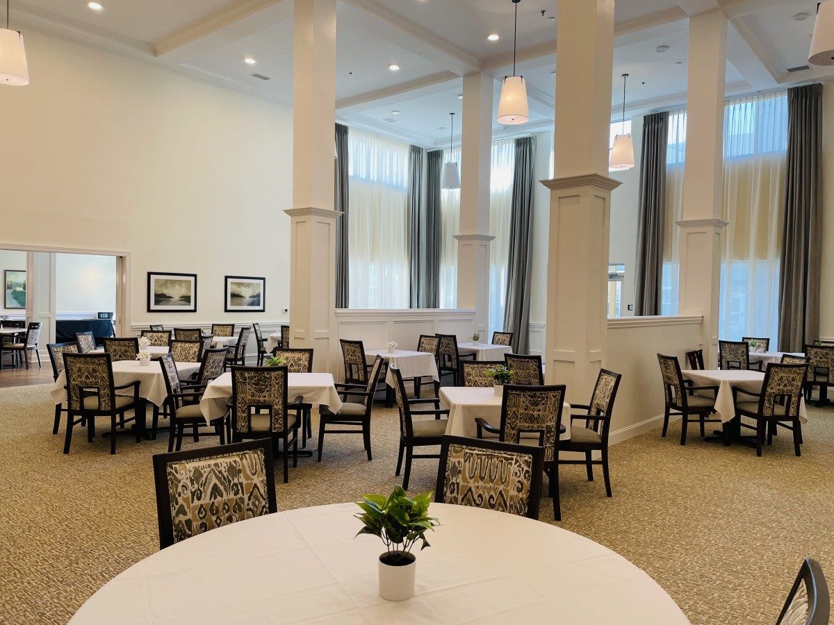 Elegantly furnished dining area with neatly arranged tables and chairs.