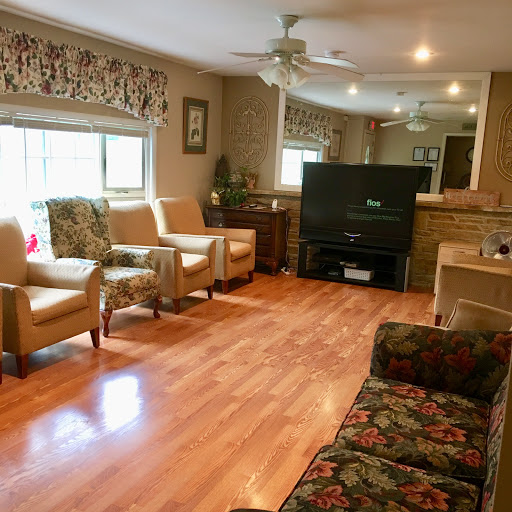 A cozy living room featuring a mix of seating options and warm wooden flooring.
