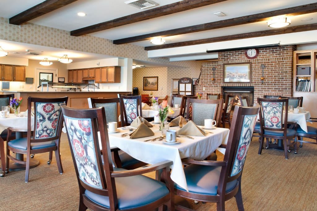 A cozy and elegant dining room with neatly arranged tables and chairs.