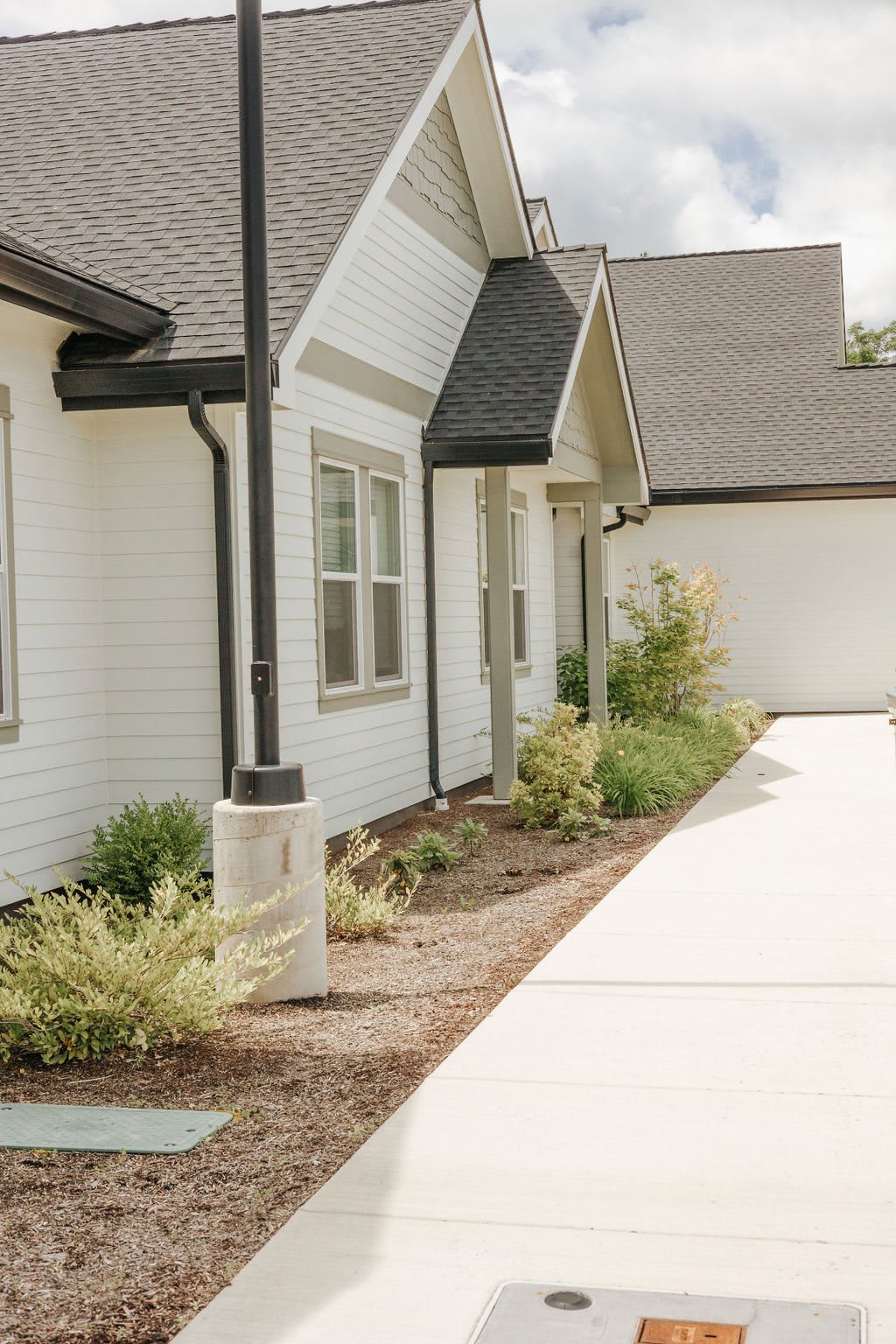 A modern residential house with a well-maintained driveway and landscaped garden.