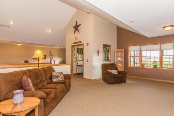 A cozy living room with comfortable seating and warm lighting.