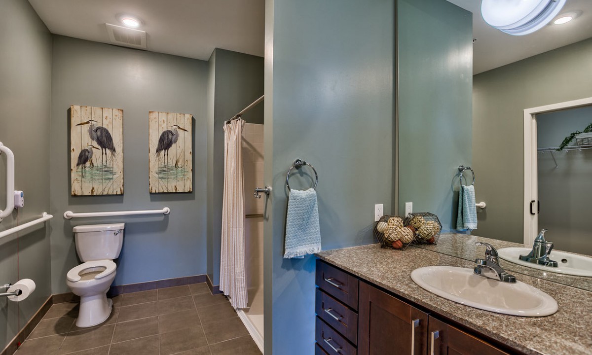 Modern bathroom with a shower, artwork, and elegant decor.
