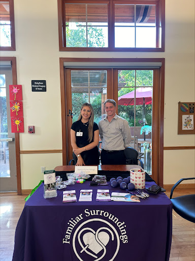 Two individuals representing a community organization at an information booth.