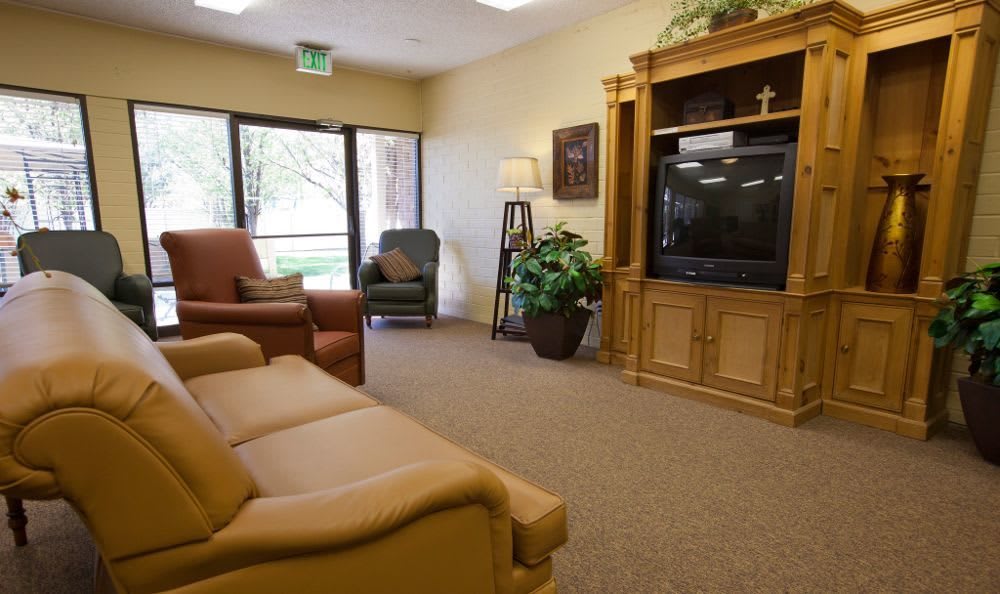 A cozy living room with comfortable seating and a large television.