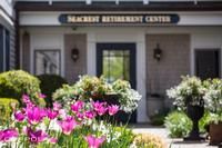 Entrance to Seacrest Retirement Center surrounded by vibrant flowers.