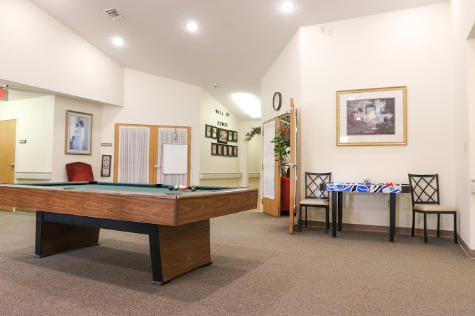 An inviting game room featuring a pool table and cozy decor.