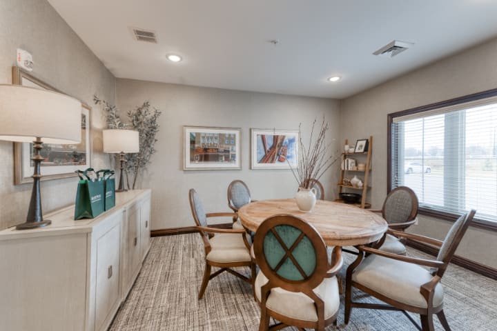 A cozy dining room with elegant furniture and tasteful decor.