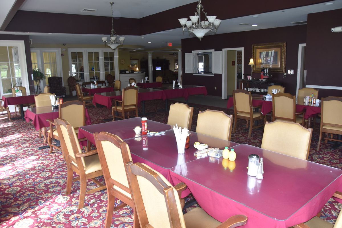 An empty restaurant dining area with arranged tables and chairs.