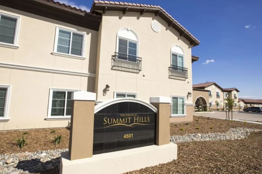 A residential building with a sign reading 'Summit Hills'.