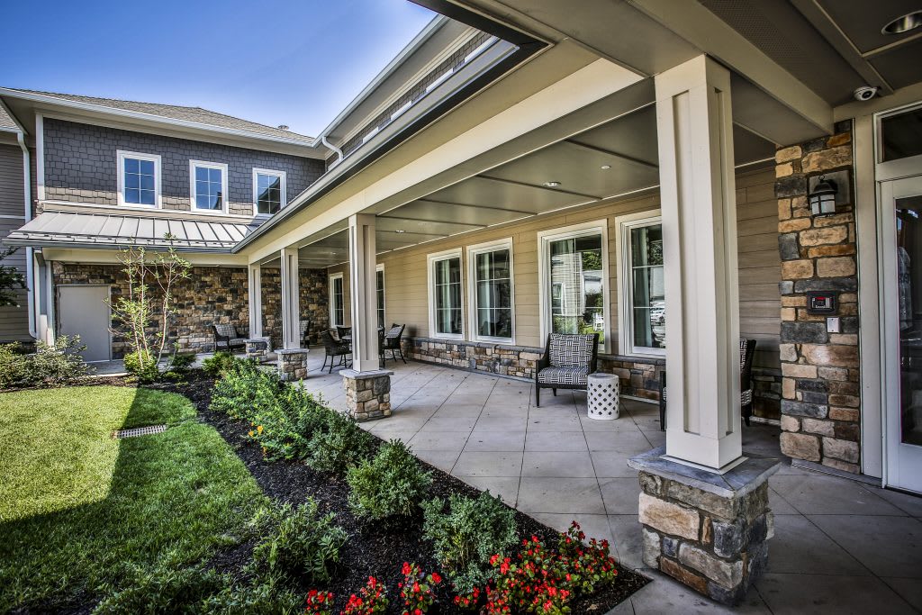 A spacious patio with outdoor seating and a well-maintained garden.