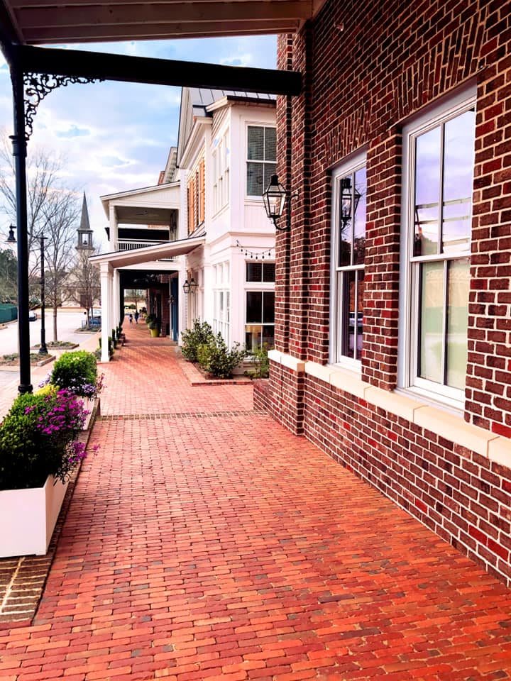 A picturesque brick sidewalk lined with classic architecture and windows.
