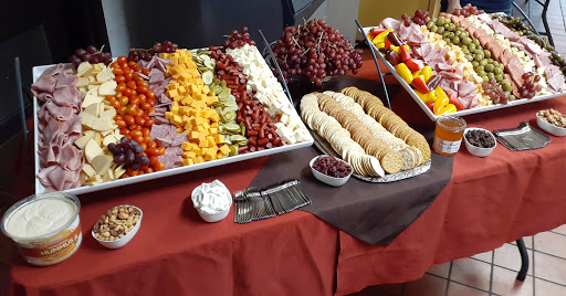 A vibrant spread of fruits, cheeses, and cookies arranged elegantly for a gathering.