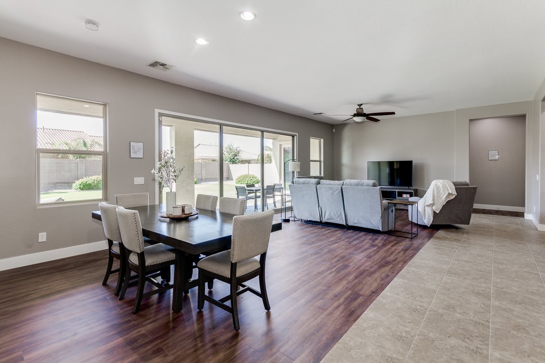 A modern open-concept living and dining area with hardwood floors and neutral color tones.