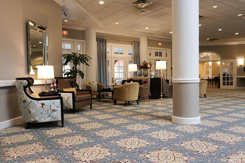 A hotel lobby featuring elegant decor, comfortable seating, and warm lighting.
