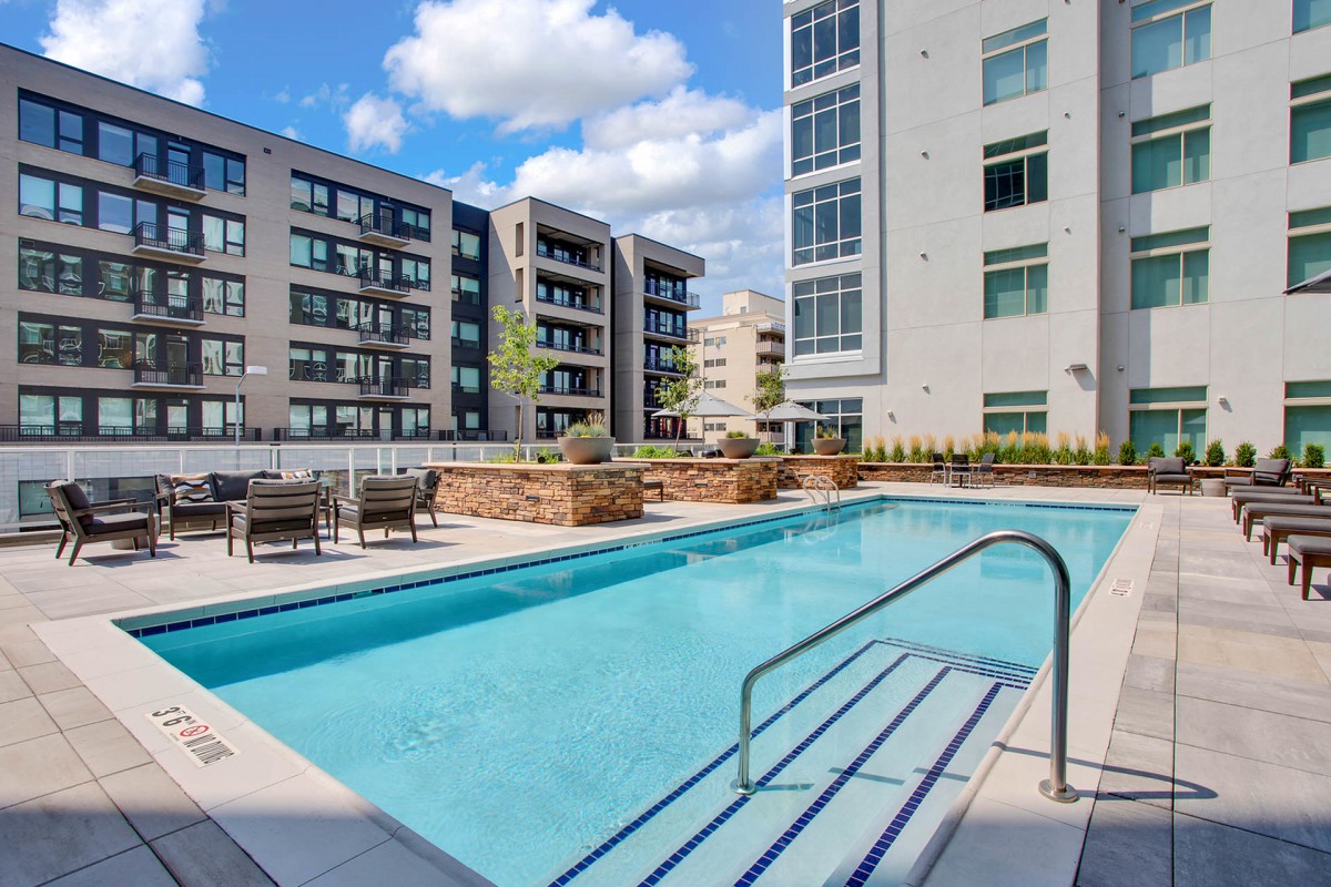 Modern apartment complex with an outdoor swimming pool.