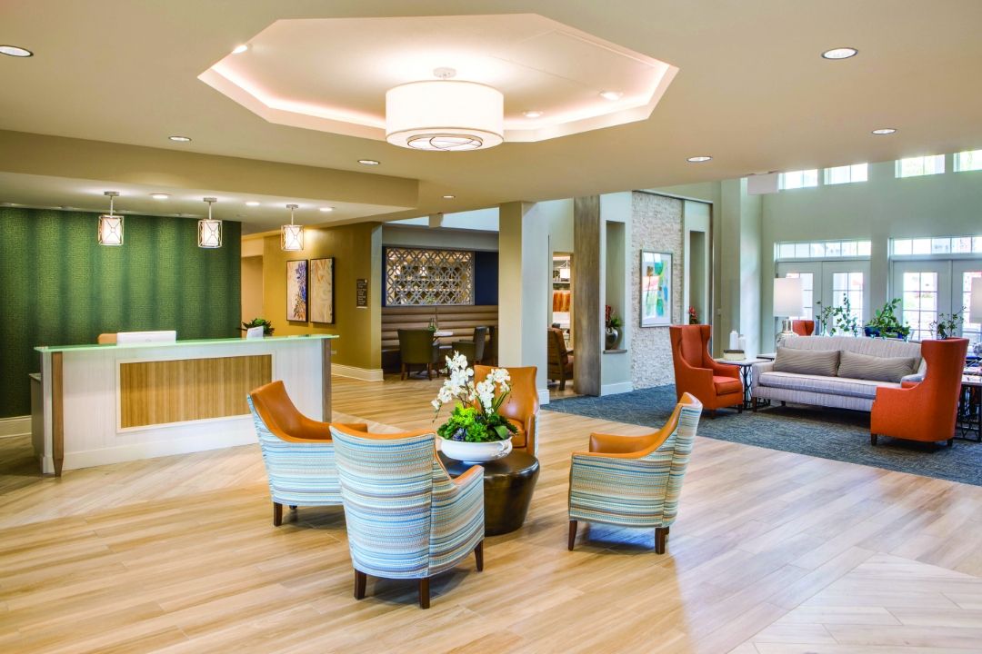 A modern lobby with comfortable seating and a reception desk.