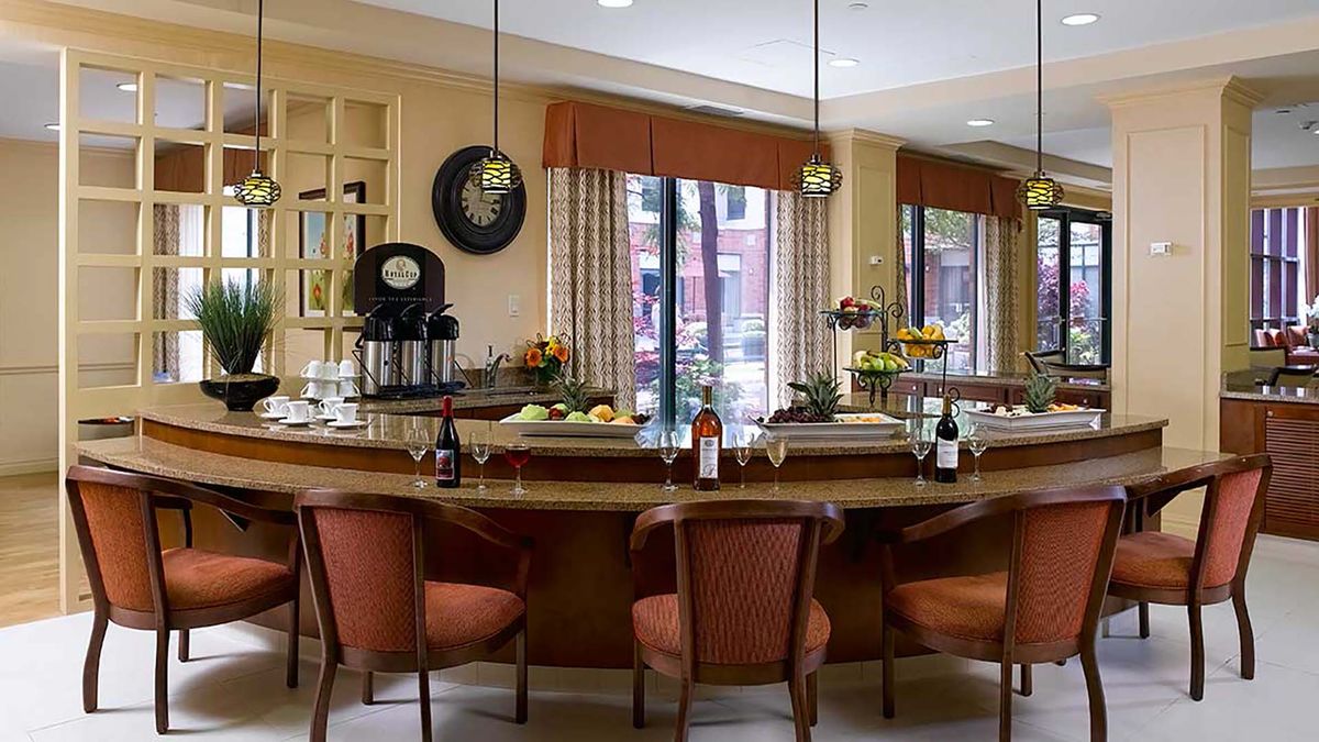 A cozy bar area with seating and a well-decorated counter.