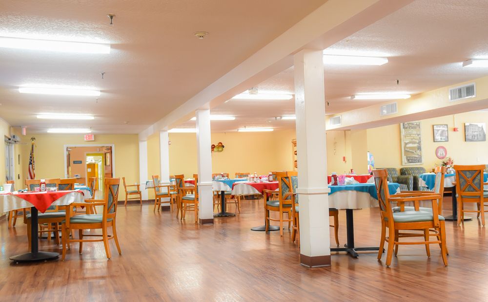 A spacious indoor dining area with tables and chairs neatly arranged.