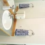 A well-organized bathroom sink area with a decorative towel and soap dispenser.
