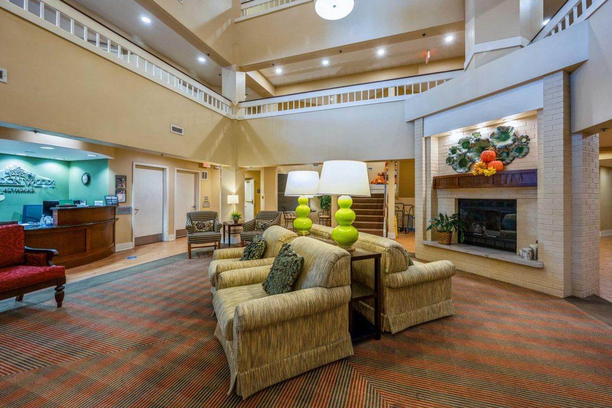 A spacious hotel lobby with comfortable seating and warm lighting.