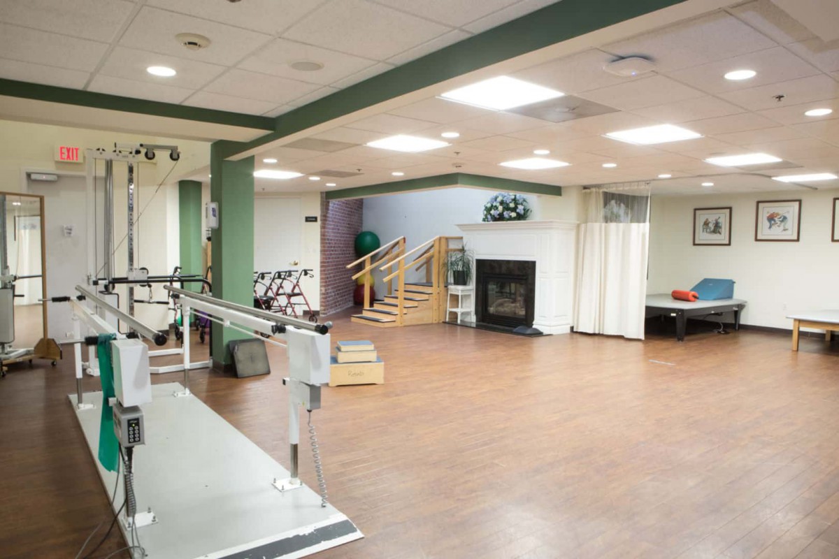 A spacious rehabilitation center with exercise equipment and therapy areas.