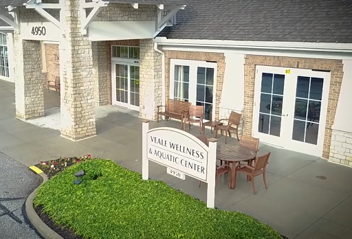 A welcoming view of a community center featuring outdoor seating and a friendly entrance.