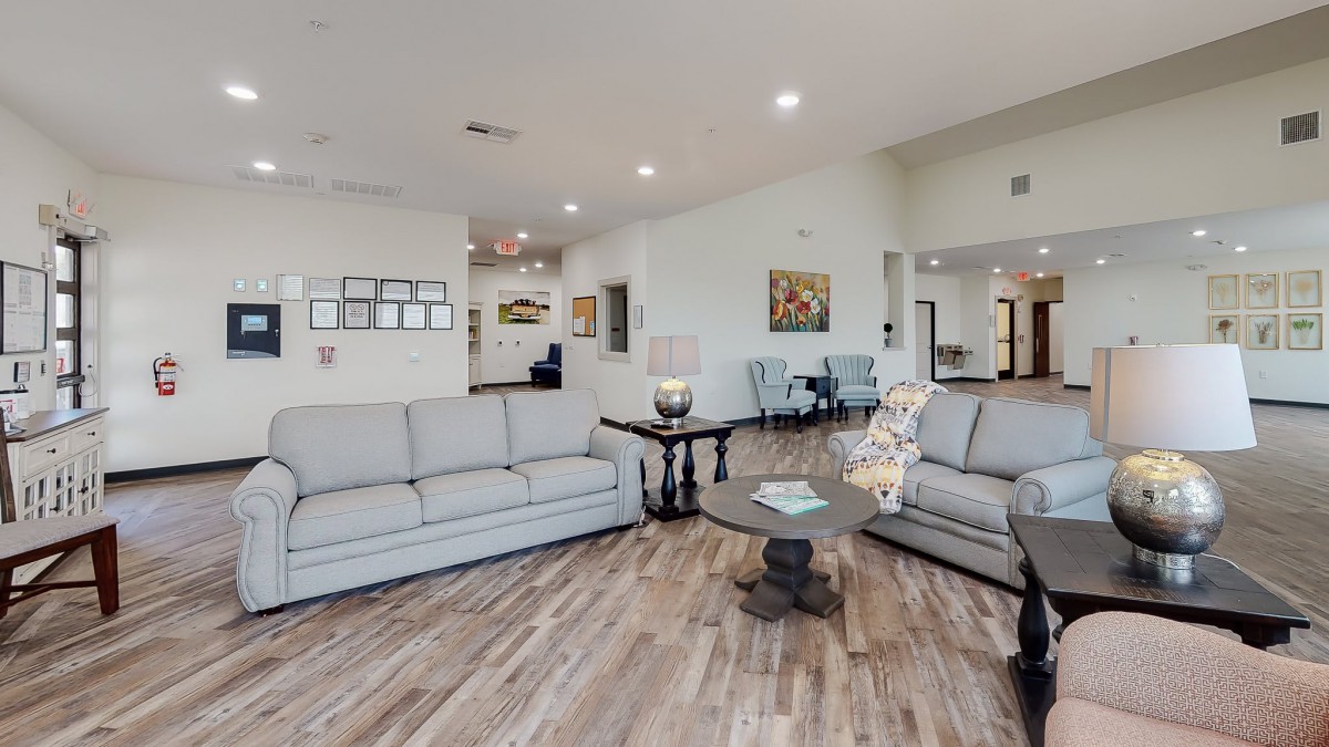 A modern living room with comfortable sofas, a central table, and elegant decor.