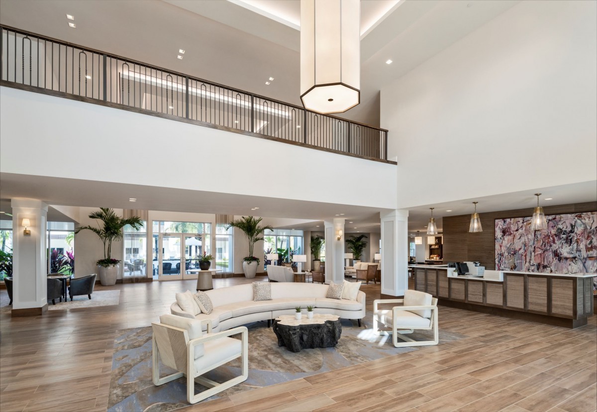 A spacious, modern lobby featuring elegant lighting and comfortable seating arrangements.