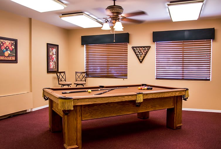 A cozy game room featuring a pool table and stylish decor.