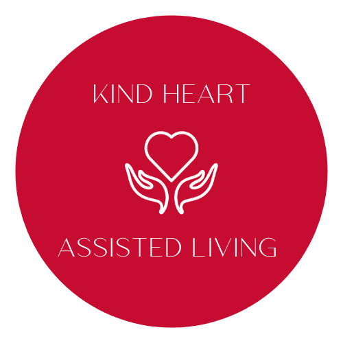 Logo for Kind Heart Assisted Living featuring hands holding a heart inside a red circle.