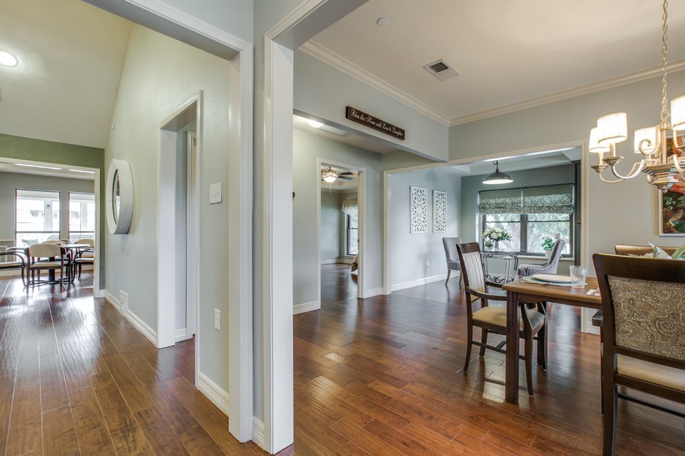 A modern dining area with hardwood floors and abundant natural light.