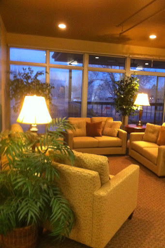 A cozy living room area with comfortable couches and warm lighting.