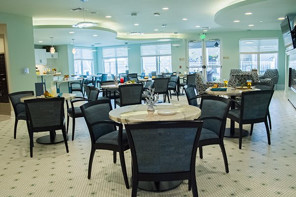 A modern dining area with neatly arranged tables and chairs, ready for guests.