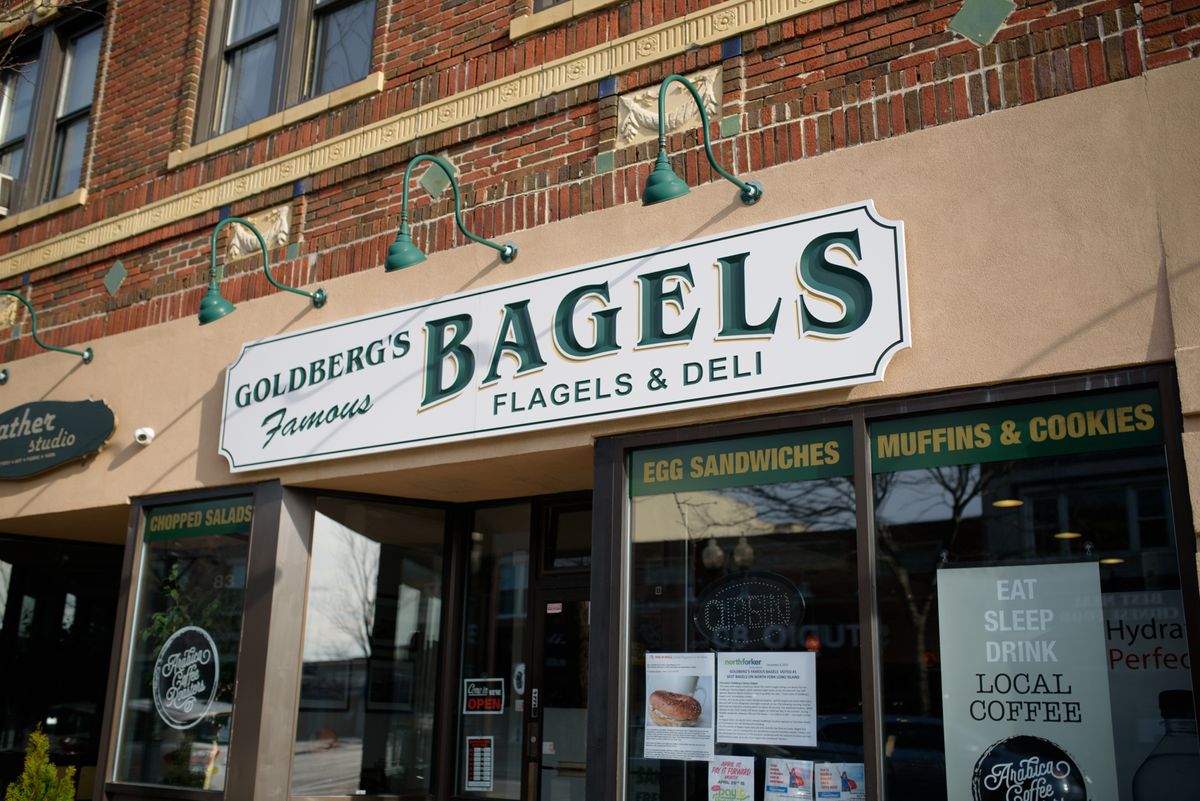 Storefront of a bagel and deli shop with prominent signage.
