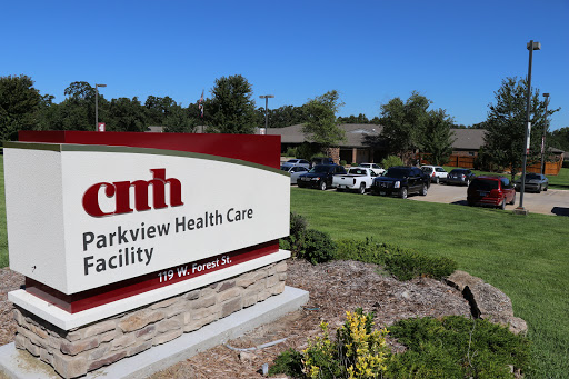 A sign for Parkview Health Care Facility with a clear blue sky in the background.