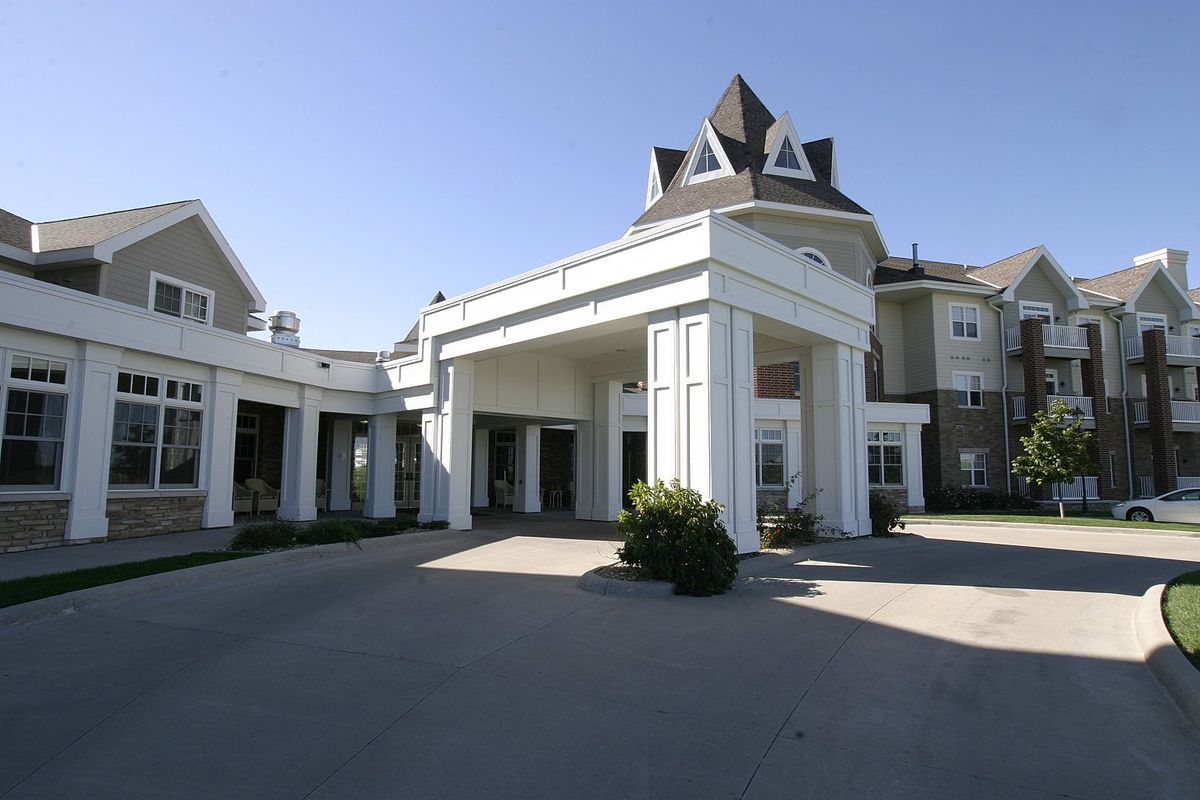 A grand entrance to a residential building with prominent columns.