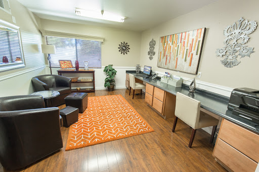 A modern office space showcasing a blend of comfort and style, featuring contemporary furniture and decor.