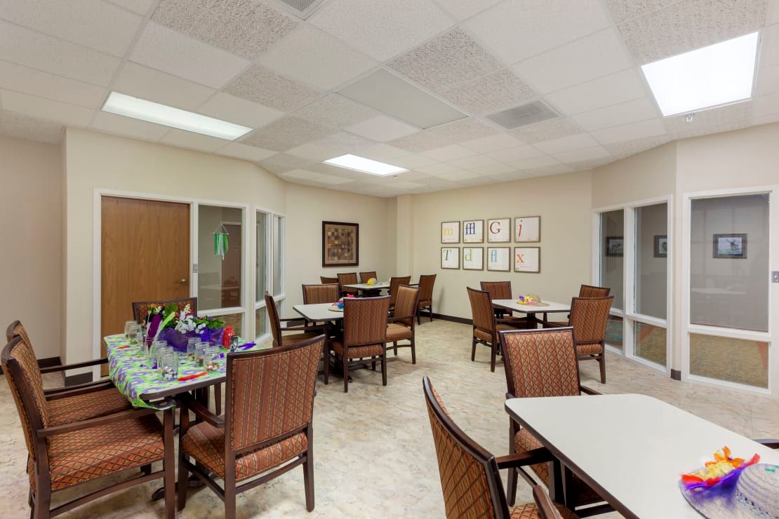 An interior view of a dining area with multiple tables and chairs arranged neatly.