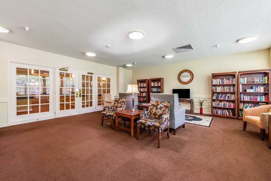 A cozy living room area with comfortable seating and bookshelves.