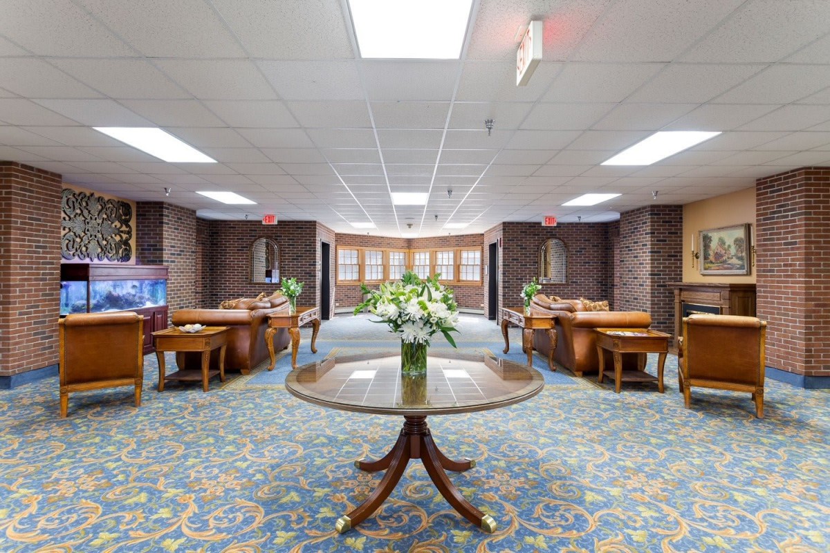 A spacious lobby area with floral arrangements and elegant furniture.