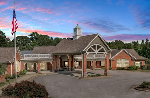 A beautifully designed residential building showcased against a picturesque sunset.