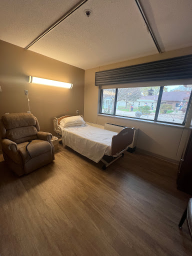 A spacious and well-lit hospital room designed for patient comfort.