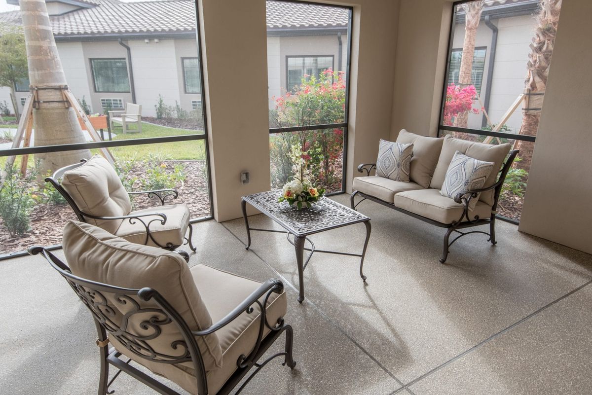 A cozy patio with elegant wrought iron furniture and a garden view.