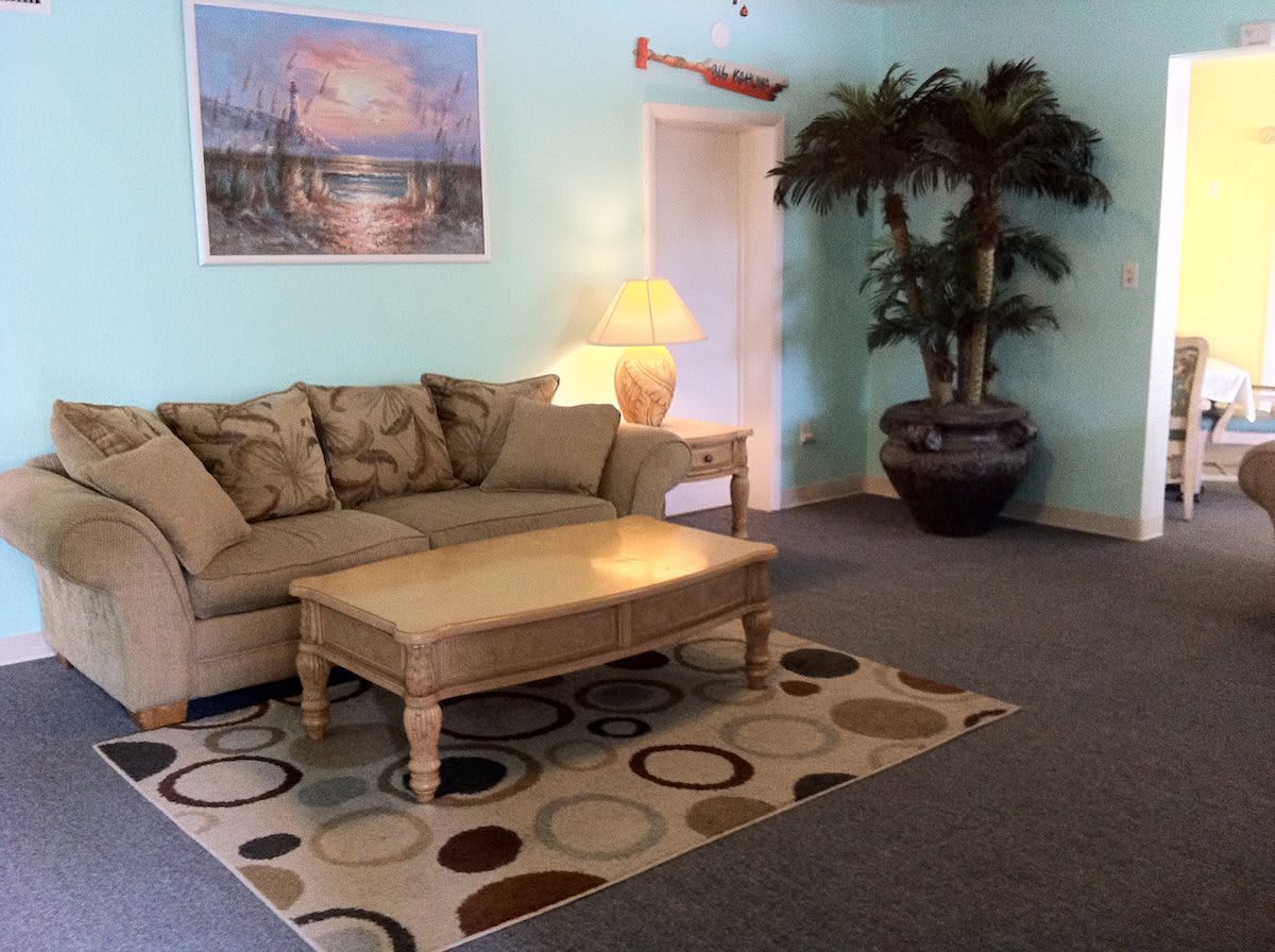 A cozy living room with a sofa, coffee table, and decorative elements.