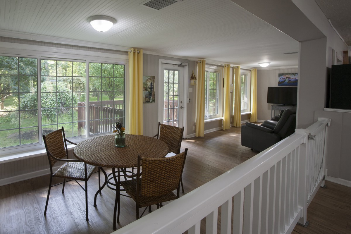 A cozy living and dining area with large windows and elegant furnishings.